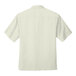 A white Port Authority short sleeve camp shirt.