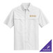 A white Port Authority short sleeve shirt with gold embroidery of a logo.