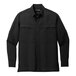 A close up of a black Port Authority long sleeve shirt with buttons and pockets.