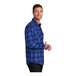 A man wearing a Port Authority blue and black plaid flannel shirt.