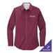 A large women's Port Authority long sleeve maroon dress shirt on a counter.