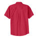 A red Port Authority short sleeve dress shirt with a light stone pattern on the cuffs and collar.