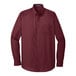 A Port Authority burgundy long sleeve poplin dress shirt.