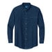 A Port & Company unisex ink blue short sleeve denim button-down shirt on a counter.