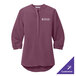 A purple Port Authority tunic blouse with a logo on the counter.