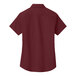 A Port Authority burgundy short sleeve poplin dress shirt for women with light stone accents.