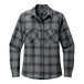 A close up of a gray and black long sleeve flannel shirt with a pocket.