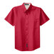 A red Port Authority short sleeve dress shirt with a white collar.