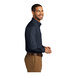 A man wearing a Port Authority River Blue long sleeve poplin dress shirt.