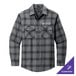 A small unisex long sleeve flannel shirt with a gray and black open plaid pattern and a logo on the pocket.