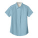 A light blue Port Authority short sleeve dress shirt for women with a tag.