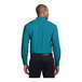 A man wearing a teal green Port Authority dress shirt with long sleeves.