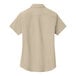 A tan Port Authority short sleeved dress shirt for women.