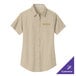 A tan Port Authority short sleeve dress shirt with a logo on it.
