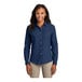 A woman wearing a Port & Company short sleeve denim button-down shirt in ink blue.