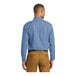 A man wearing a Port & Company faded blue short sleeve denim button-down shirt.