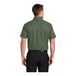A man wearing a Port Authority clover green short sleeve dress shirt.