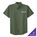 A Port Authority clover green short sleeve dress shirt with white text on the counter.