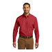 A man wearing a Port Authority long sleeve red poplin shirt.