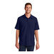 A man wearing a navy Port Authority short sleeve shirt.