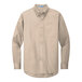 A Port Authority long-sleeved tan button-down dress shirt.