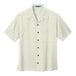 An ivory Port Authority short sleeve camp shirt for men with a buttoned collar and two buttons.