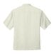 A white Port Authority short sleeve camp shirt.