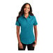 A woman wearing a Port Authority teal green short sleeve button down dress shirt.