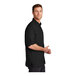 A man wearing a black Port Authority stretch poplin shirt.