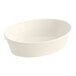 An ivory oval bowl with a curved edge on a white background.
