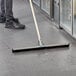 A person using an Ettore floor squeegee to clean a floor.