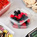 A plastic container of Gustaf's red and black licorice berries.