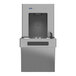 A Sloan stainless steel water dispenser for filling bottles.