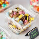 A plastic container of Gustaf's Licorice Allsorts on a counter.
