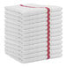A stack of white Monarch Brands bar towels with red stripes.