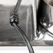 A black cable plugged into a silver box.