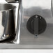 A close up of a Fama Electric Hard Cheese Grater.