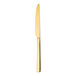 A Sola the Netherlands Durban Gold stainless steel butter knife with a white handle.
