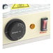 The control panel with a temperature dial and power switch on a Carnival King hot food display case.