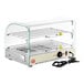 A Carnival King curved glass countertop food warmer with wire shelves.