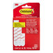 A red box of 3M Command assorted foam adhesive strips with white and red strips.