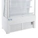 An Avantco white refrigerated air curtain merchandiser with glass doors.