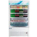An Avantco white refrigerated air curtain merchandiser full of beverages.