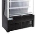 An Avantco black refrigerated air curtain merchandiser with glass doors.