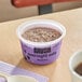 A cup of Oats Overnight Blueberry mush on a table.