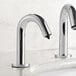 A close-up of a Waterloo chrome automatic soap dispenser on a white counter.