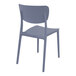 A dark gray plastic Siesta Monna outdoor dining chair with a backrest.