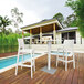 A Siesta Jamaica white wickerlook resin barstool on a deck.