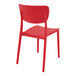 A red resin Siesta Monna outdoor dining chair with a backrest.