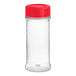 A clear plastic spice container with a red lid.